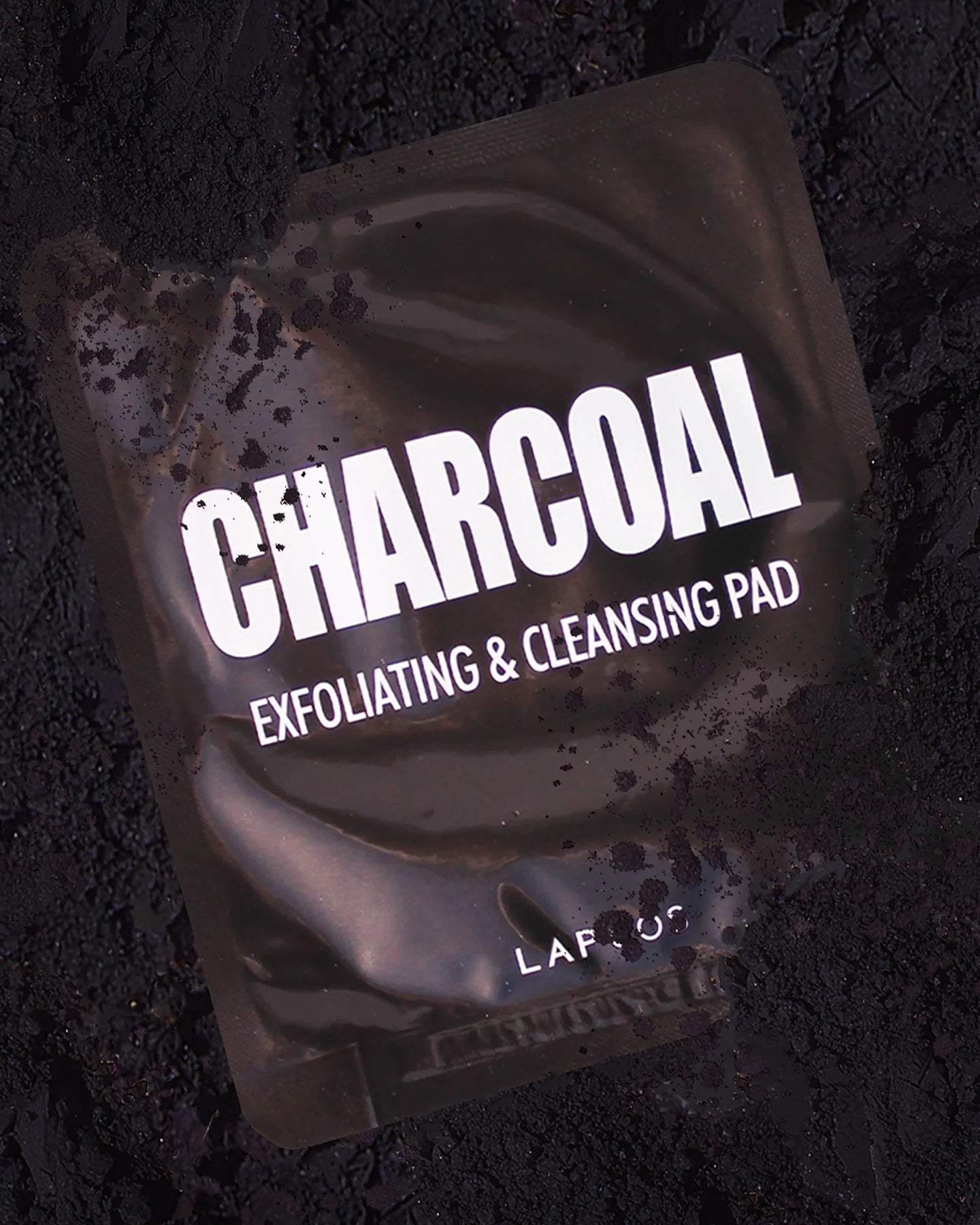 This Exfoliating &amp; Cleansing pad is made with purifying Charcoal Powder to draw environmental pollutants and toxins to the skin’s surface, like skin rehab. Remove heavy makeup, dirt and oil from pores without irritating your complexion via a dual sided pad. Dissolve impurities while refining skin texture, and minimizing the appearance of pores. Soybean also promotes skin elasticity and moisture for a springy post-cleanse look and feel.